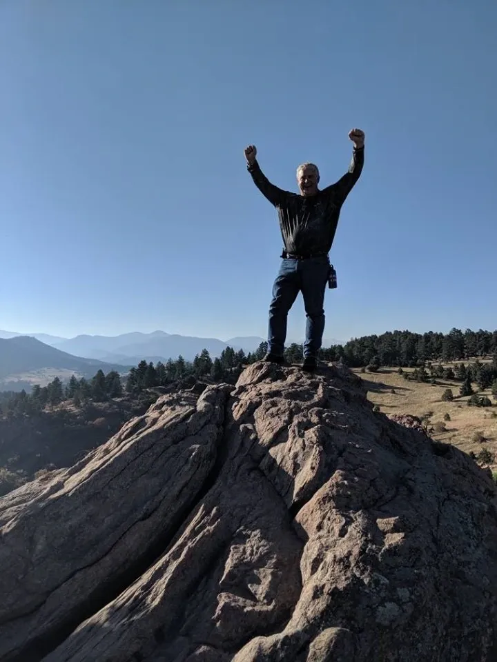 Traveler celebrating on a mountain summit