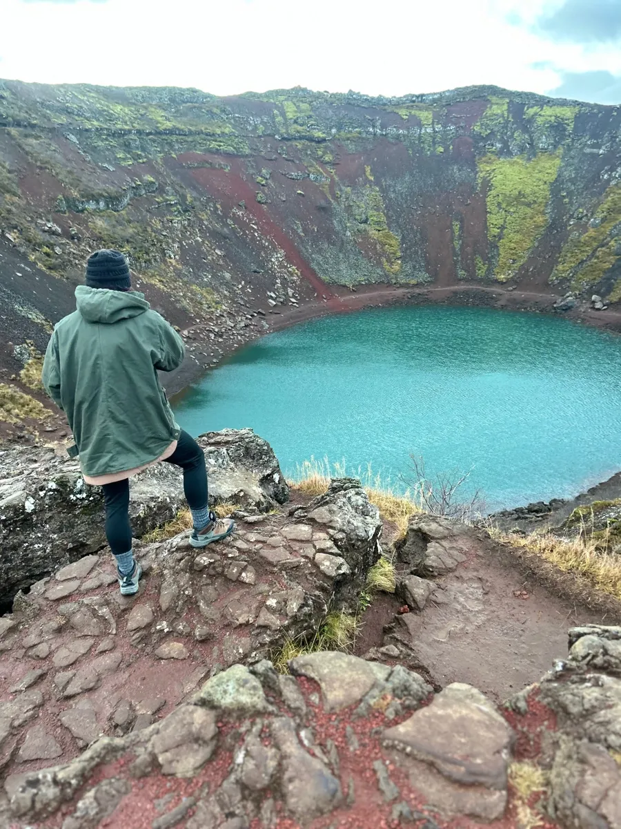 Traveler overlooking a volcanic crater lake